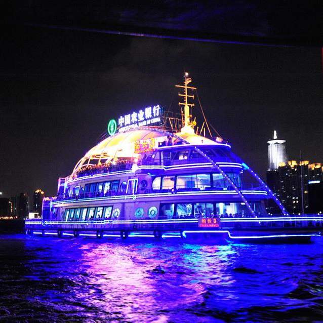 Ship illuminated with decorative lighting at night
